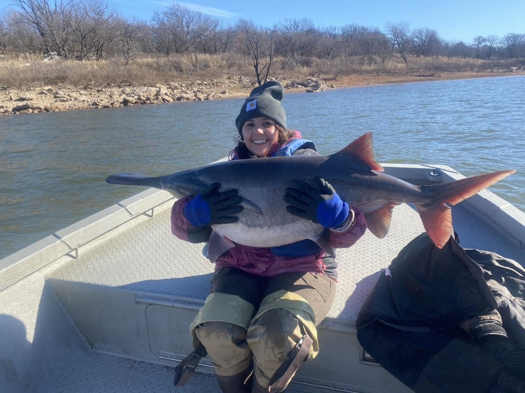 Sarah Southerland holding a large fish on a boat