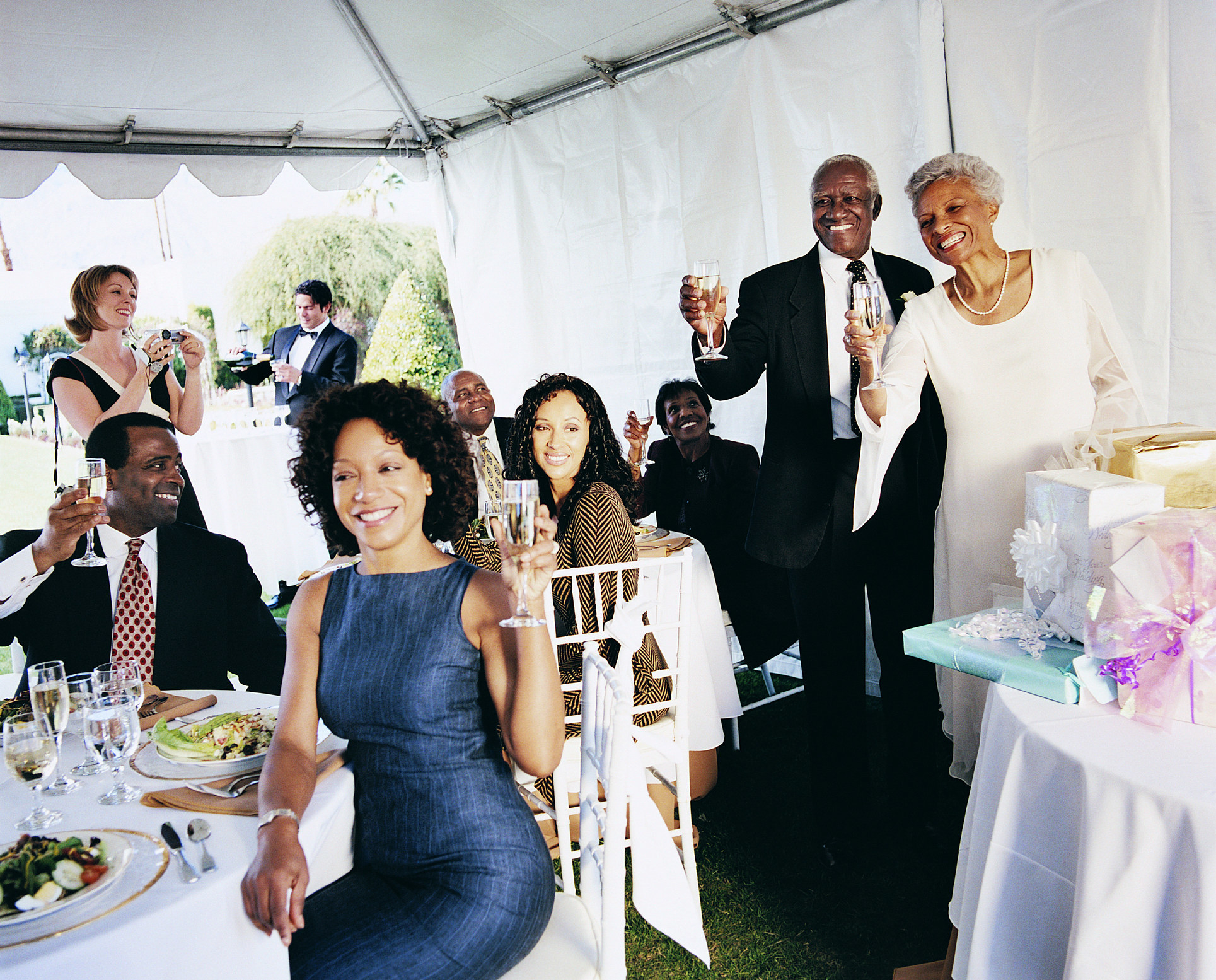 wedding guests holding up their champagne for a toast