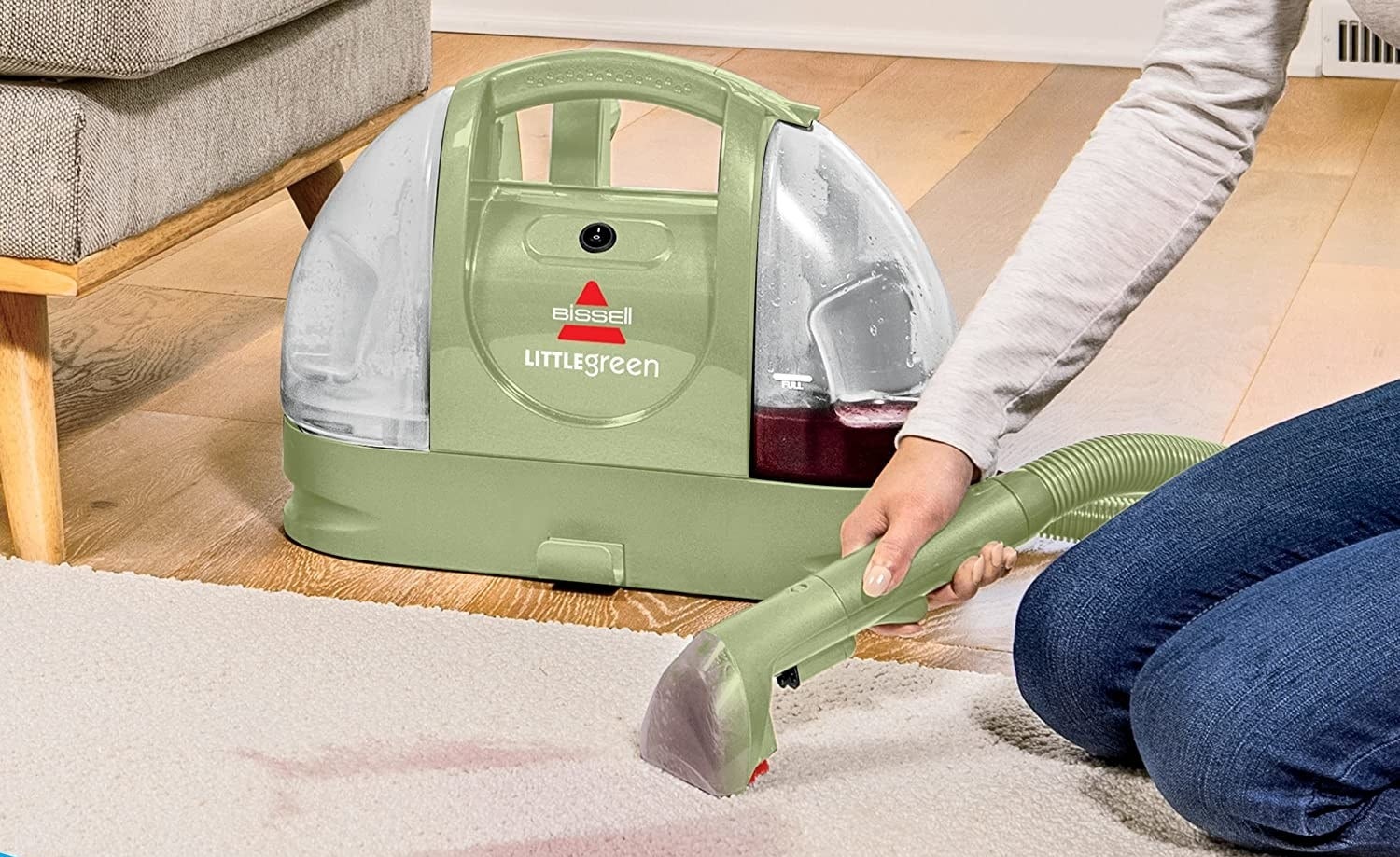 A person using the Little Green on their carpet