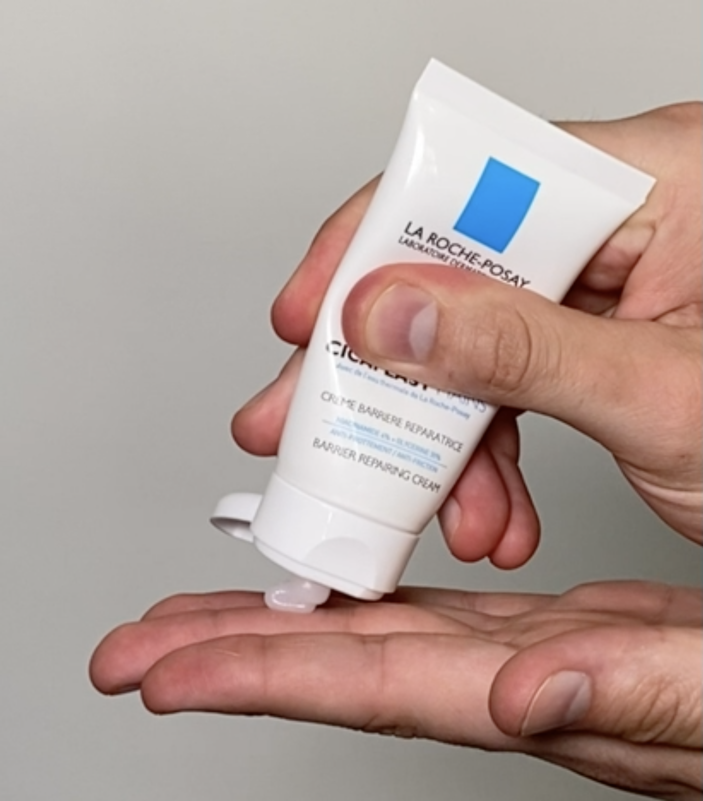person applying the cream to their hand