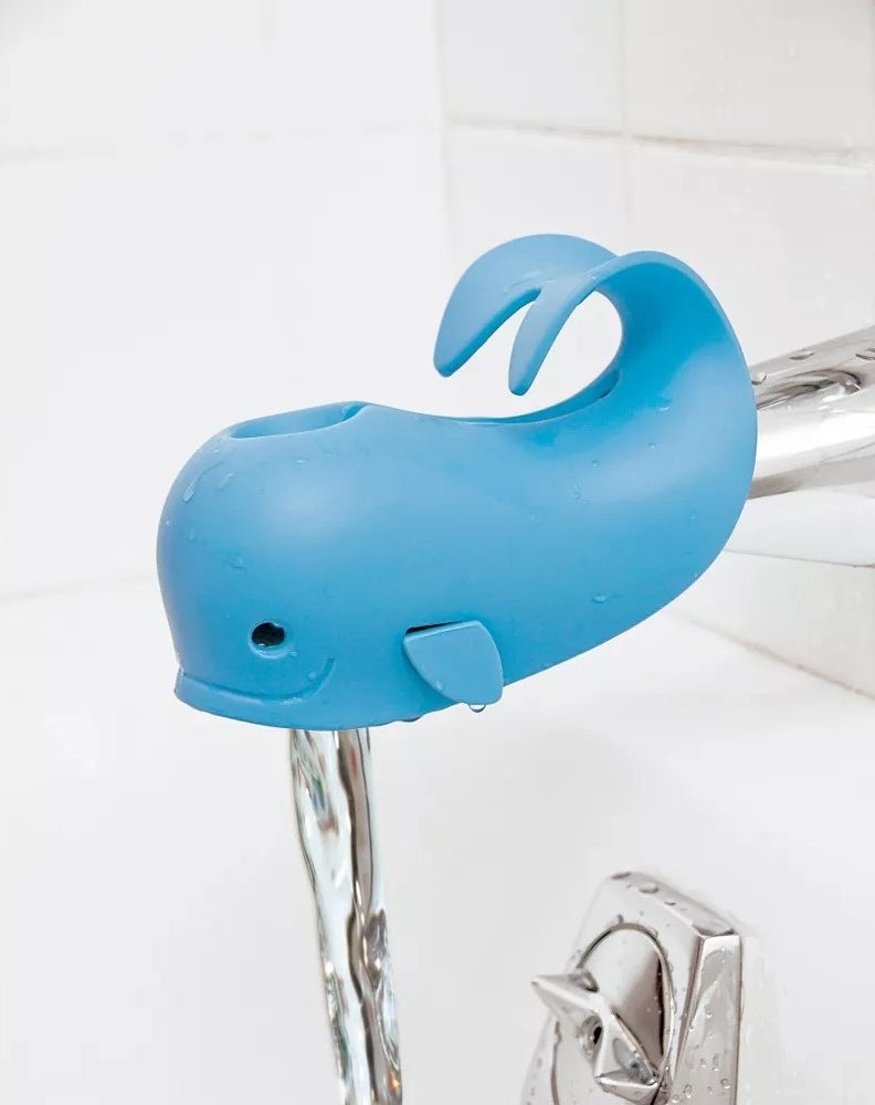 Light blue whale shaped cover on bath tub spout