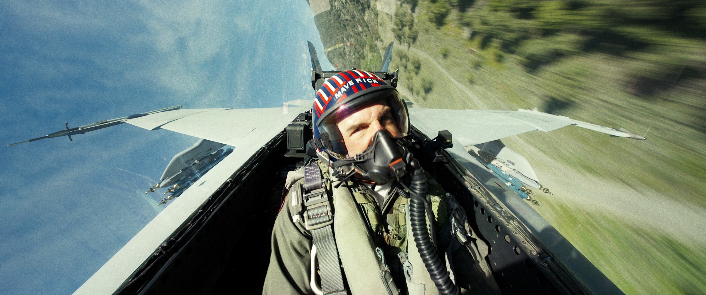 Tom Cruise piloting a plane and wearing a respirator