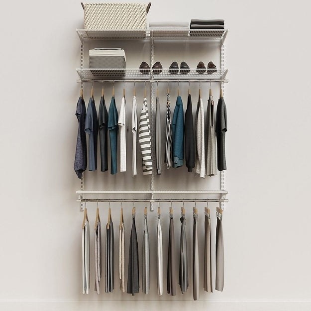 The adjustable closet organizer which has two dowels for hanging clothes and two shelves for baskets/extra storage
