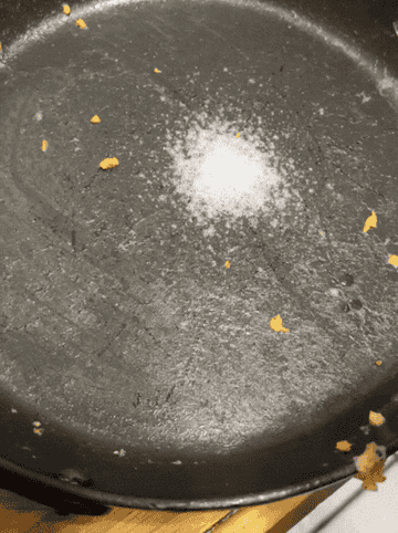 a gif of a person spraying pan with Dawn Powerwash