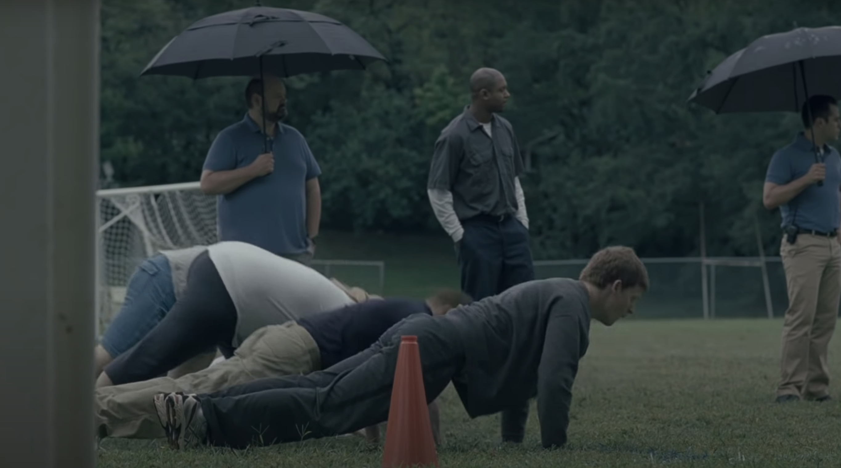 teens doing push ups while coaches look on