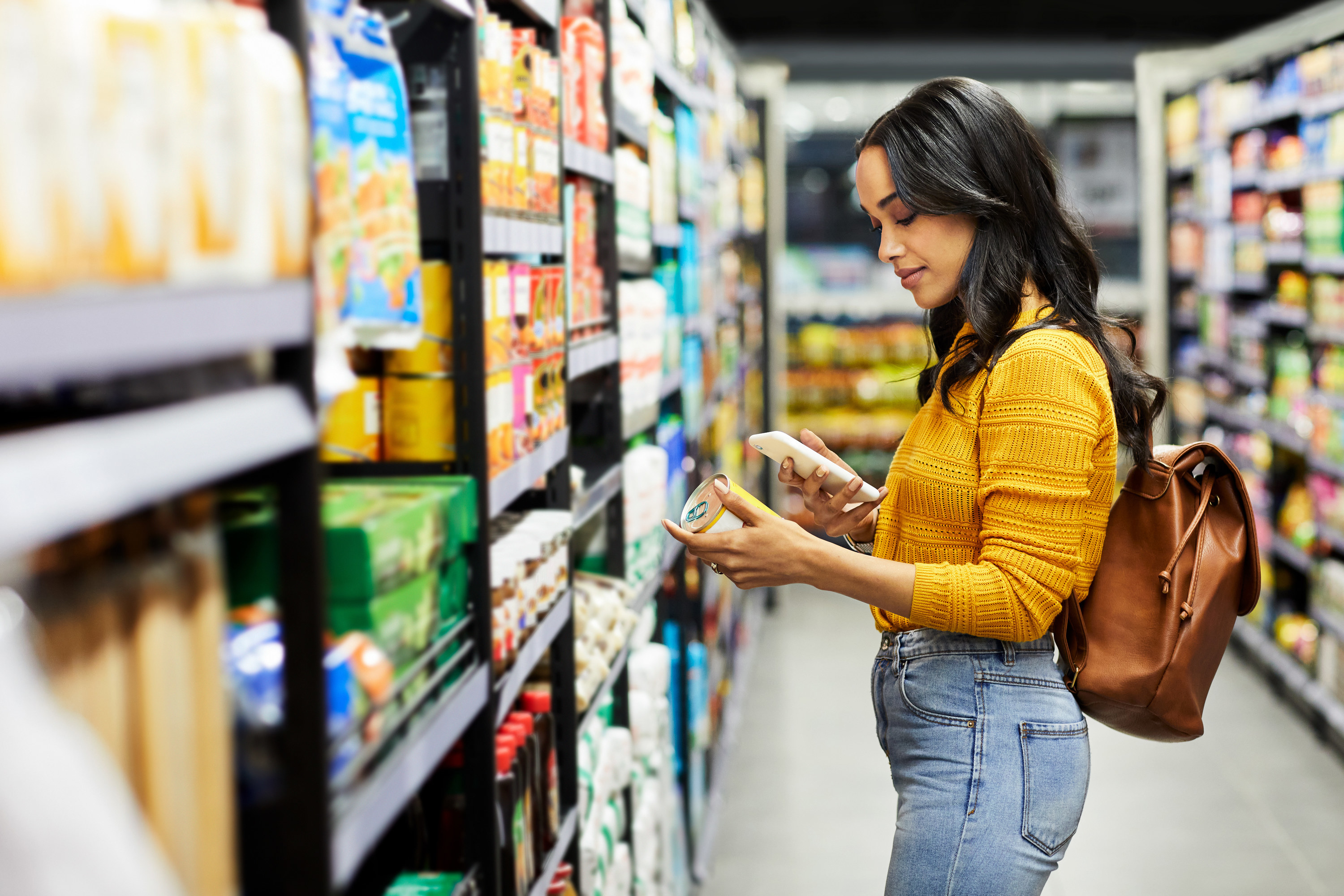 woman looking at her phone in the grocery store