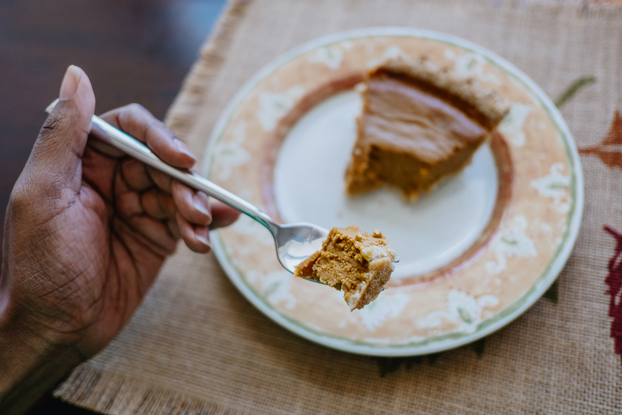 Eating a piece of pumpkin pie with a fork