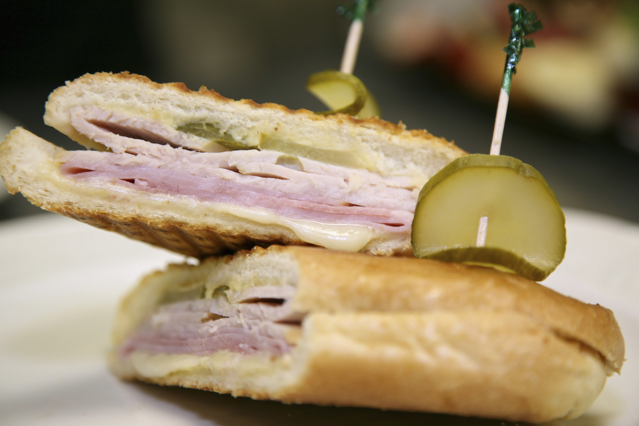 A Cuban sandwich topped with pickles