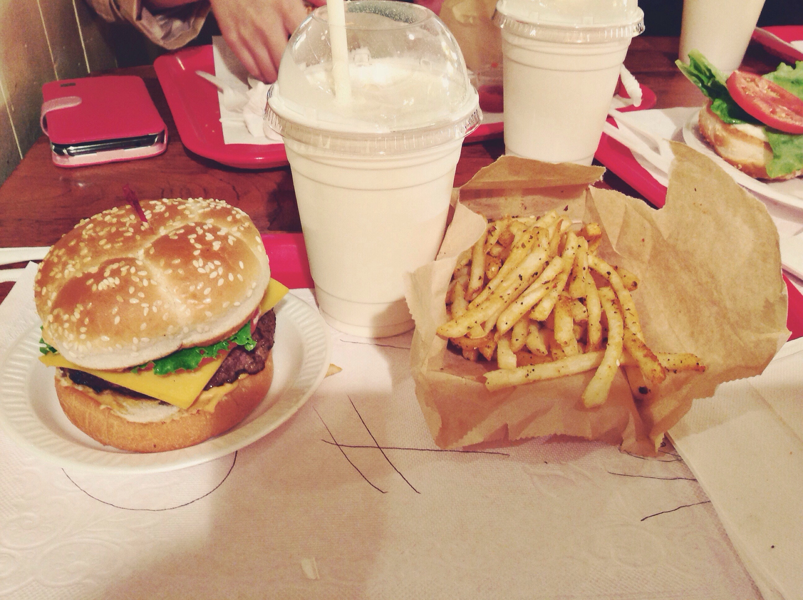 A burger, shake, and fries at a restaurant