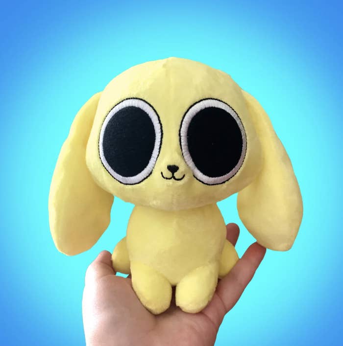 Someone holding the yellow plushie