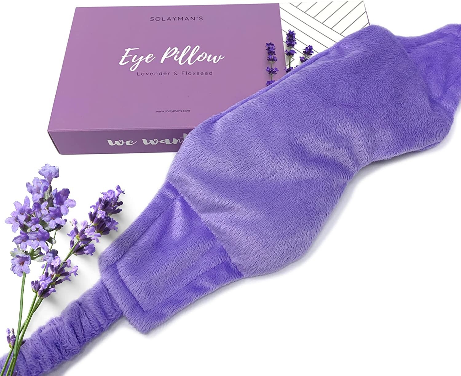 the lavender eye mask beside the packaging and a lavender plant