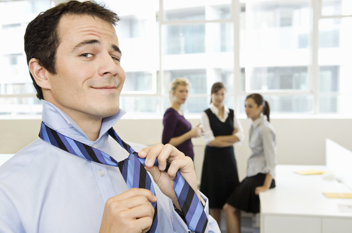 person putting on a tie