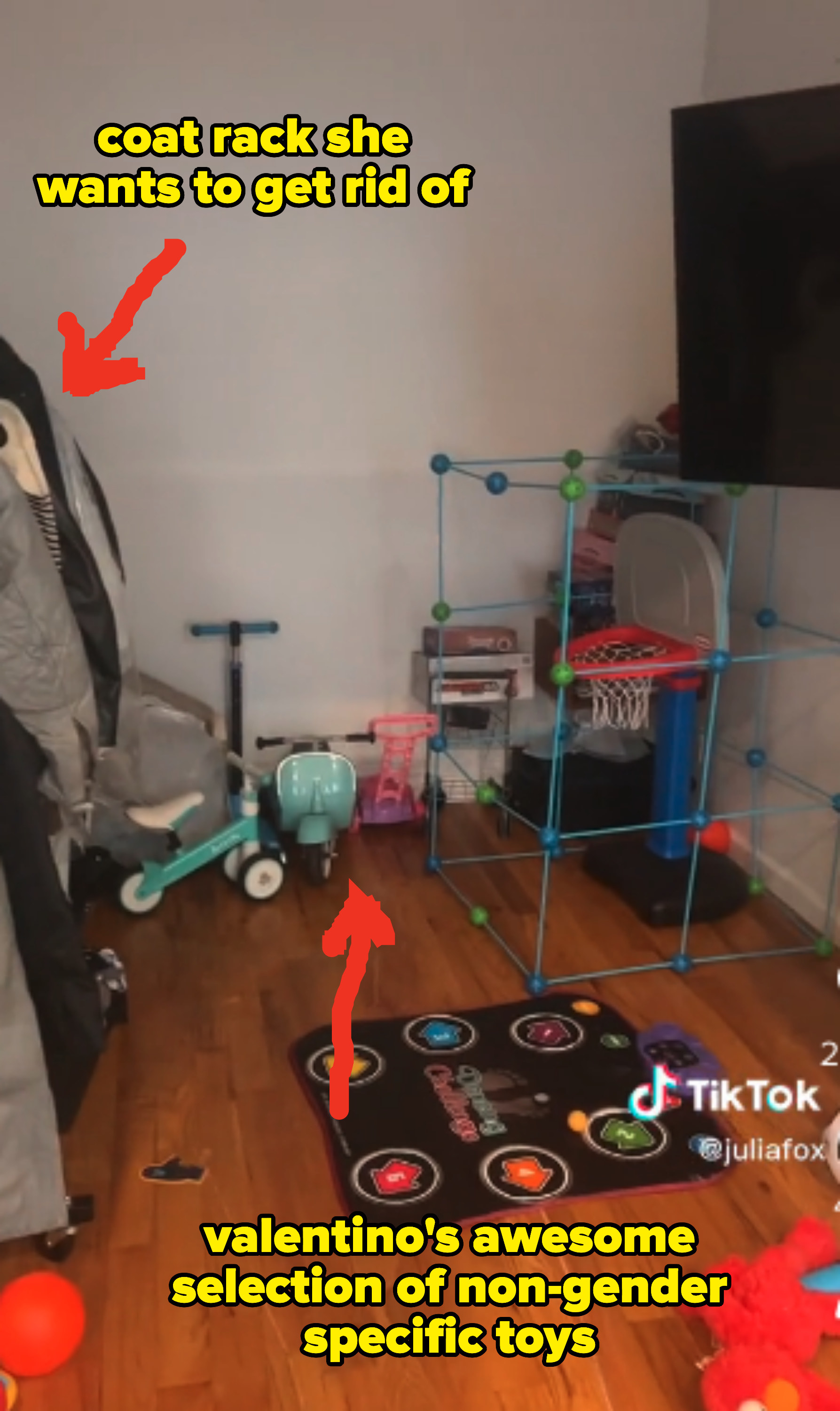 A coat rack that Julia wants to get rid off is on the left side of the room and her son Valentino&#x27;s non-gender specific toys, including a mini basketball hoop and a scooter, fill the rest of the space