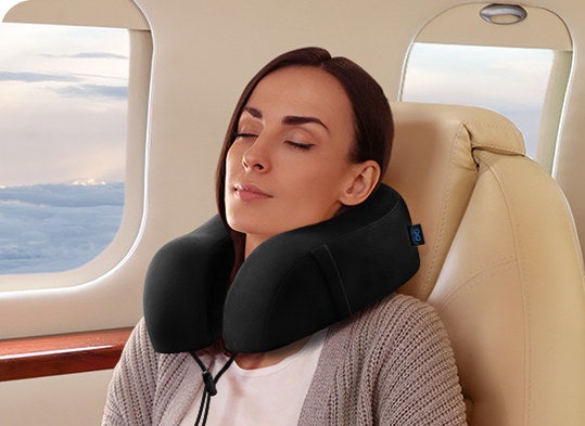 someone sleeping on a plane with the neck pillow on