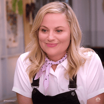 Amy Poehler clapping and smiling