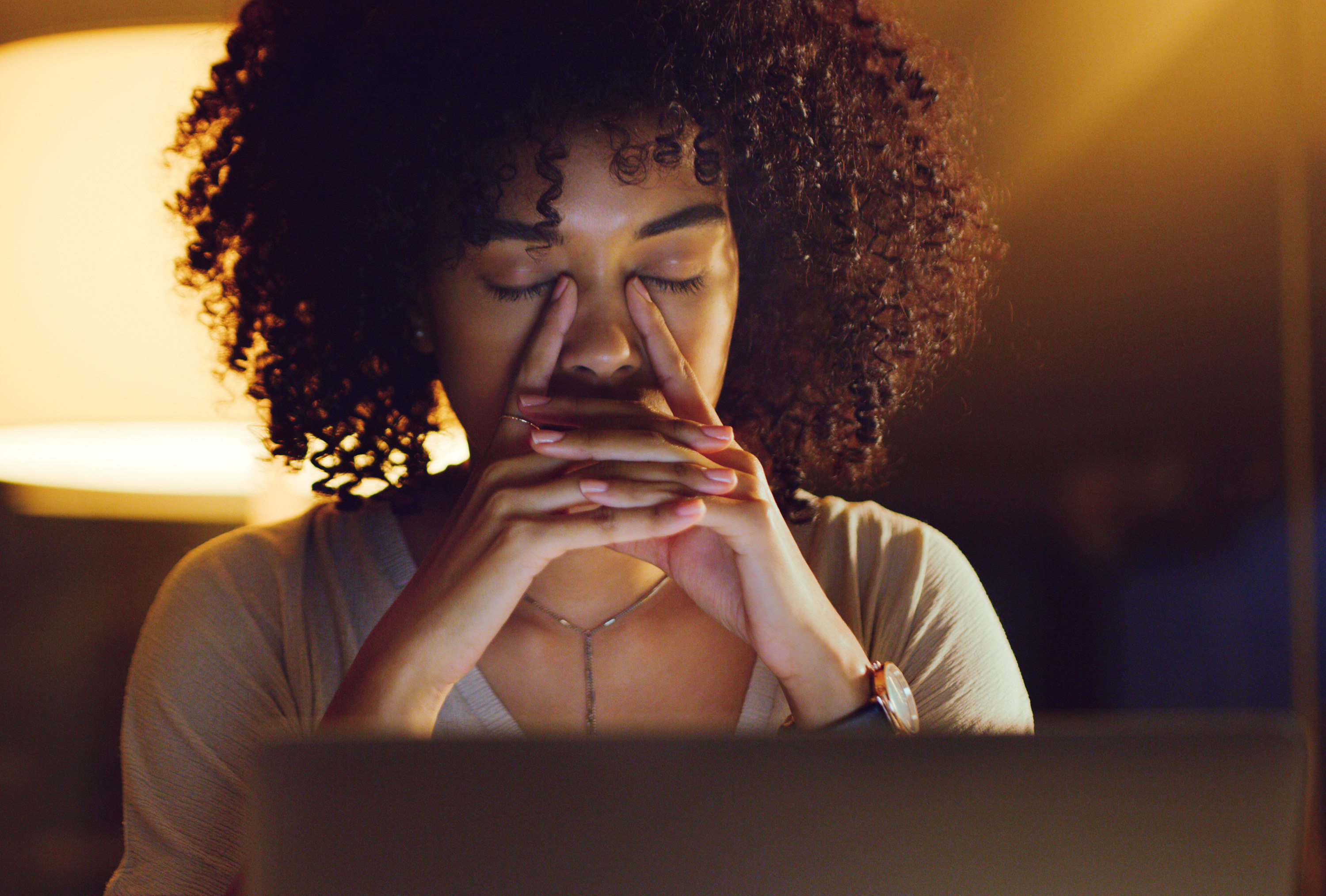 a woman looking anxious in front of her computer