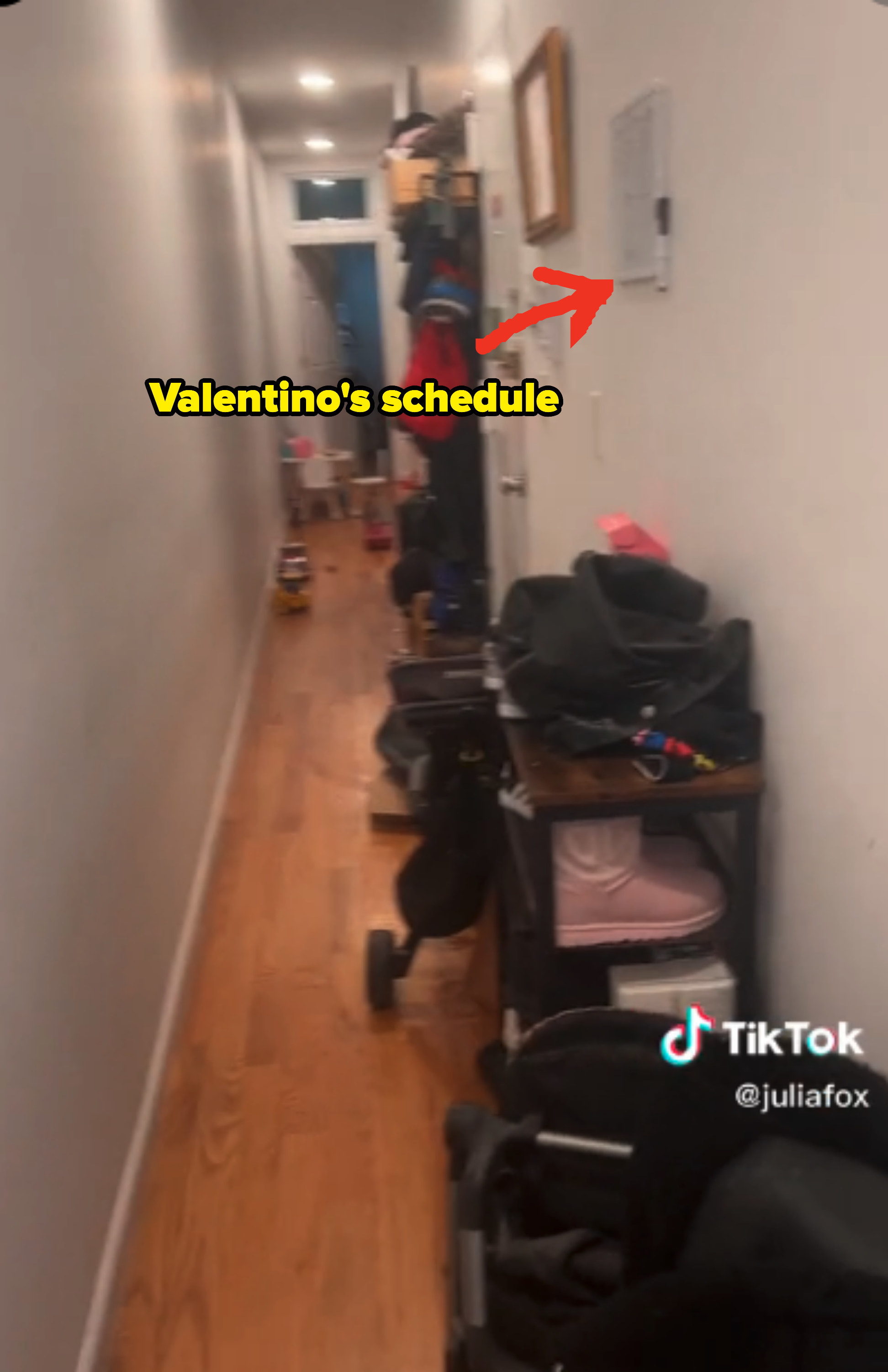 An arrow points at Valentino&#x27;s schedule on the wall that is lined with a shoe rack and strollers