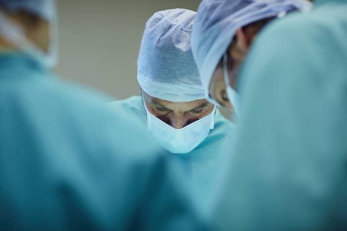 surgeons working in operating room at hospital