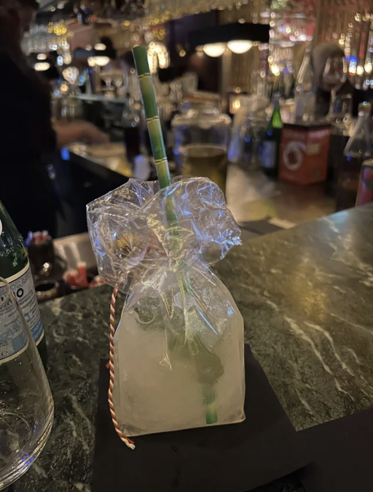 A cocktail in a see-through plastic bag tied with a string