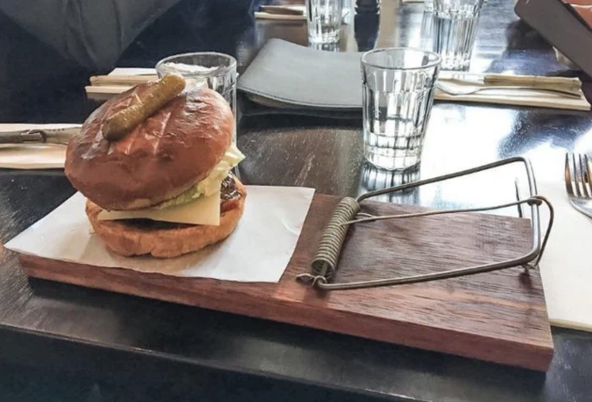 A burger in what looks like a mouse trap with a spring