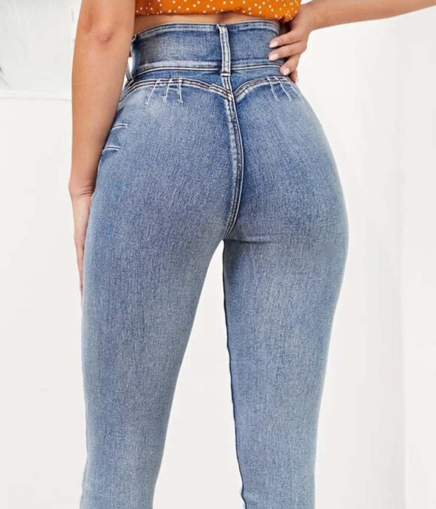 A person wearing a pair of very high-waisted, form-fitting jeans with zero pockets in sight