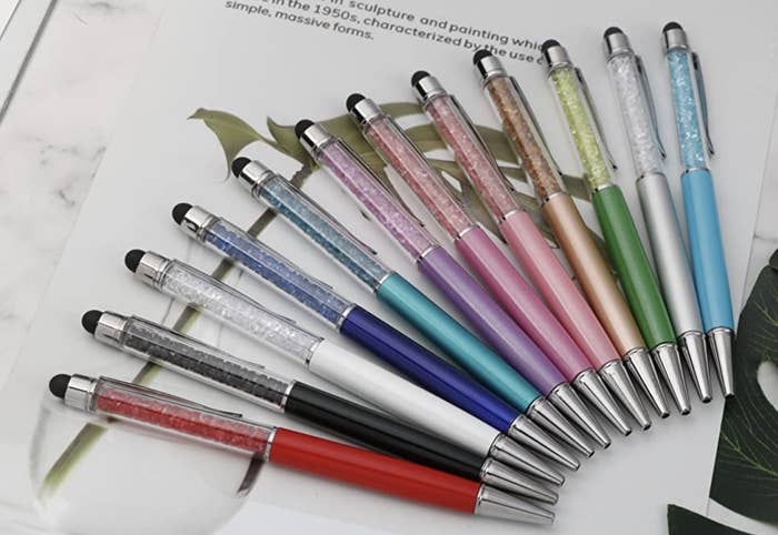 all of the pens lined up on a notebook