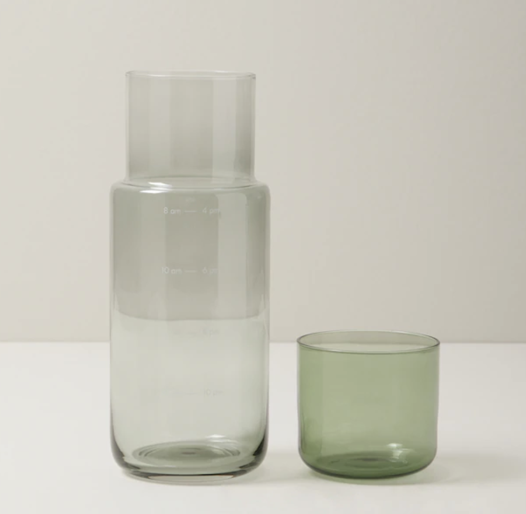 the glass carafe set in front of a plain background