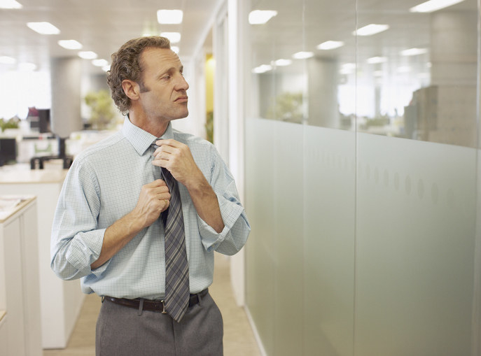 person adjusting their tie