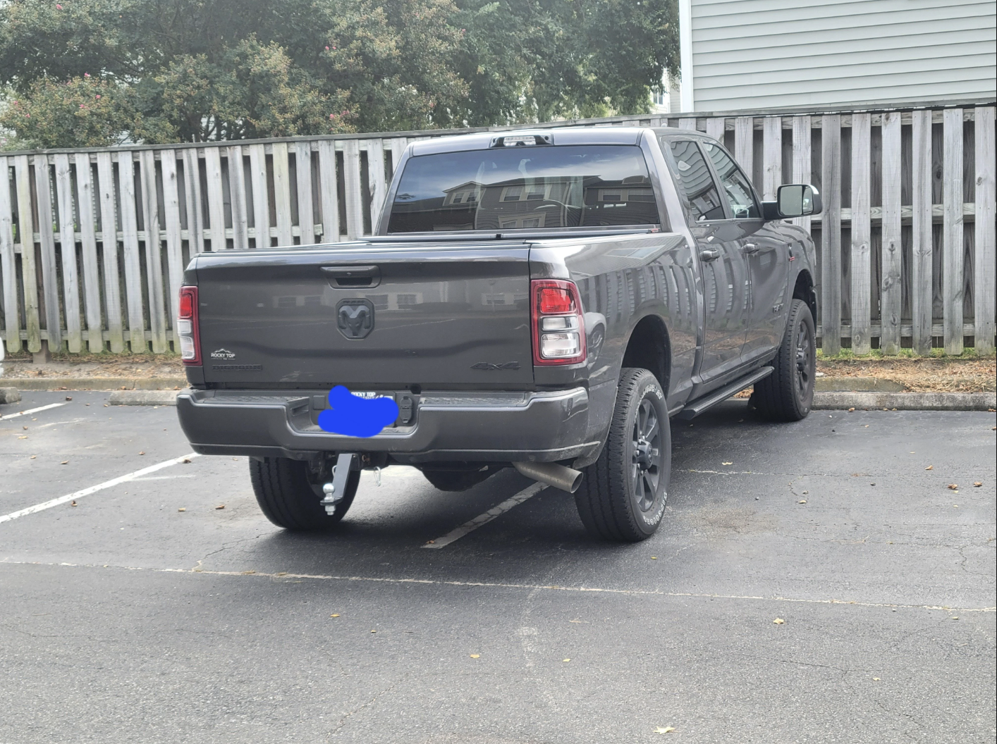 A truck is parked so that it&#x27;s covering half of two parking spaces