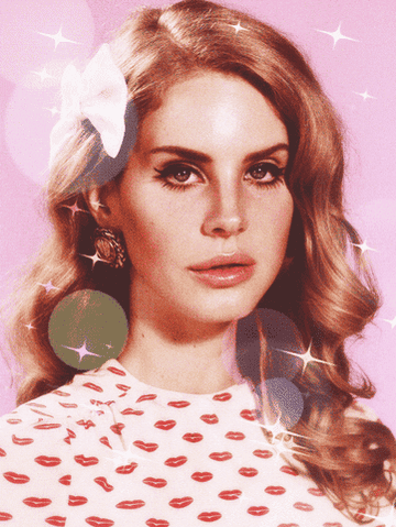 Lana Del Rey wearing a bow, winged liner, and a shirt with pink and red kiss marks