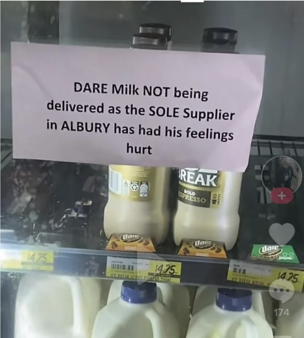 &quot;DARE Milk NOT being delivered as the SOLE Supplier in Albury has had his feelings hurt&quot; sign on the door of the milk section