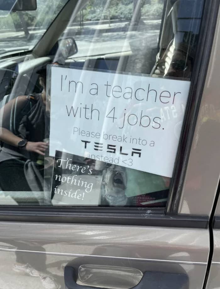 Car sign: I&#x27;m a teacher with 4 jobs; please break into a Tesla instead&quot;