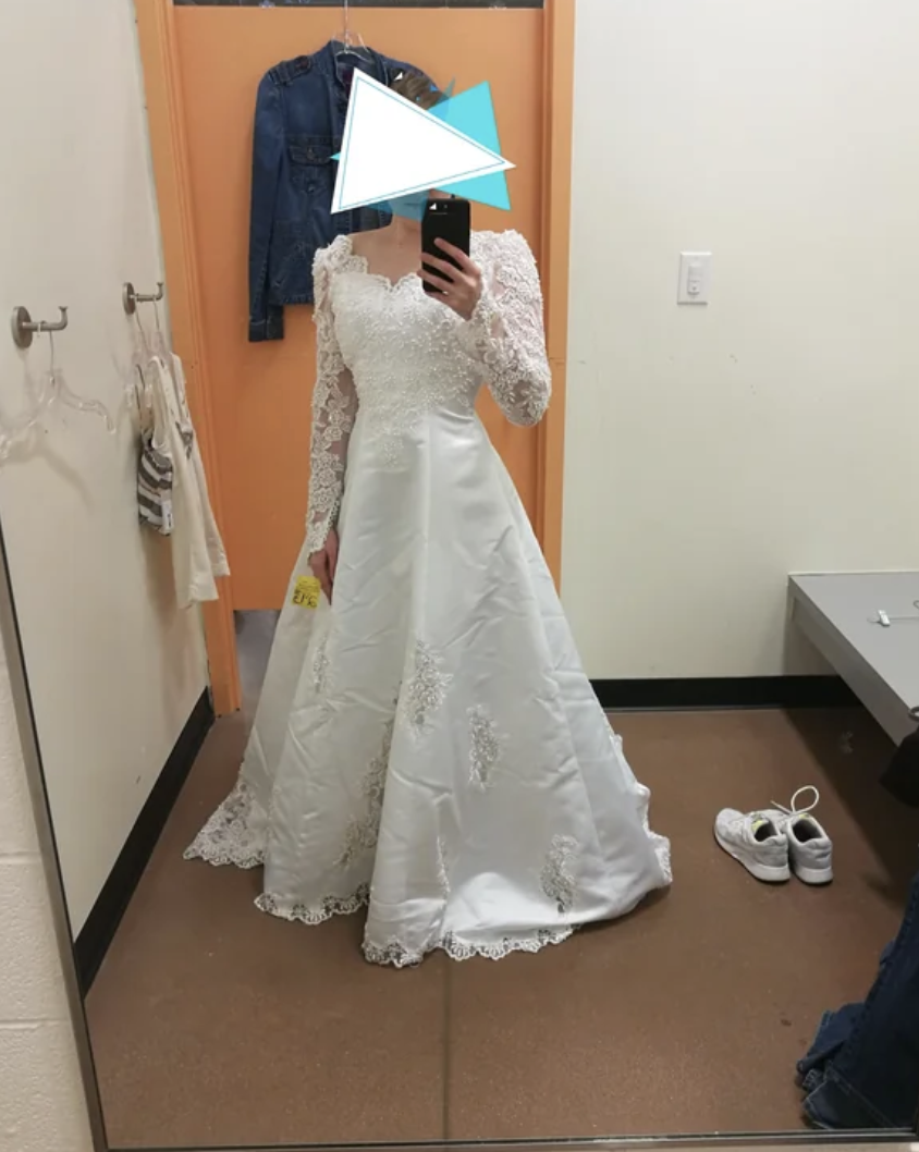 A woman trying on a wedding dress