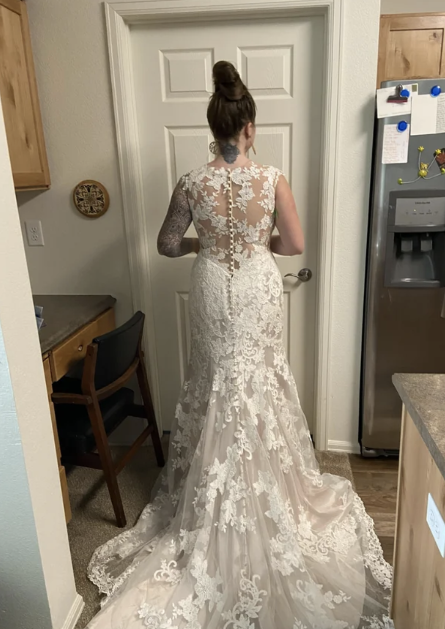 A woman trying on a wedding dress