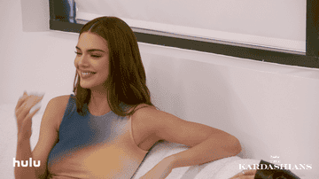 Kendall Jenner covers her mouth while laughing