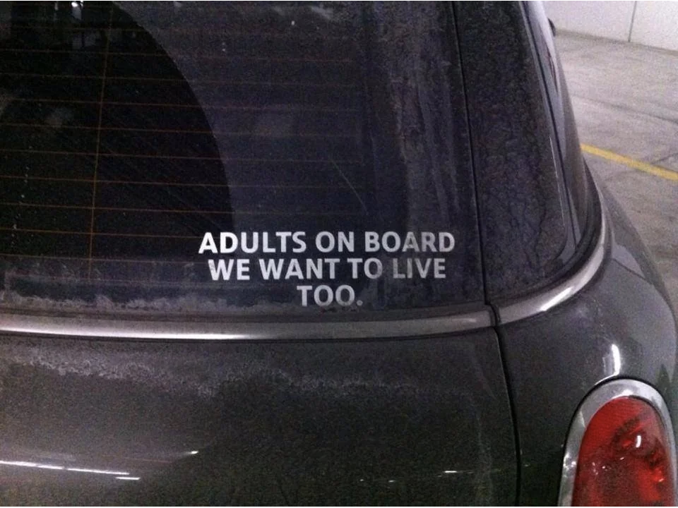 sticker that reads &quot;adults on board we want to live too&quot;