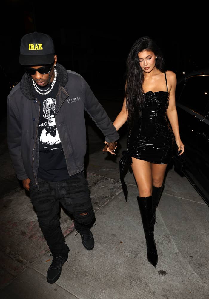 Travis and Kylie walking outside hand in hand