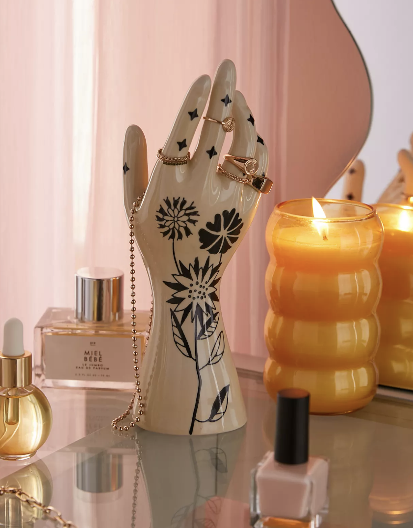 the hand with jewellery on it on a vanity