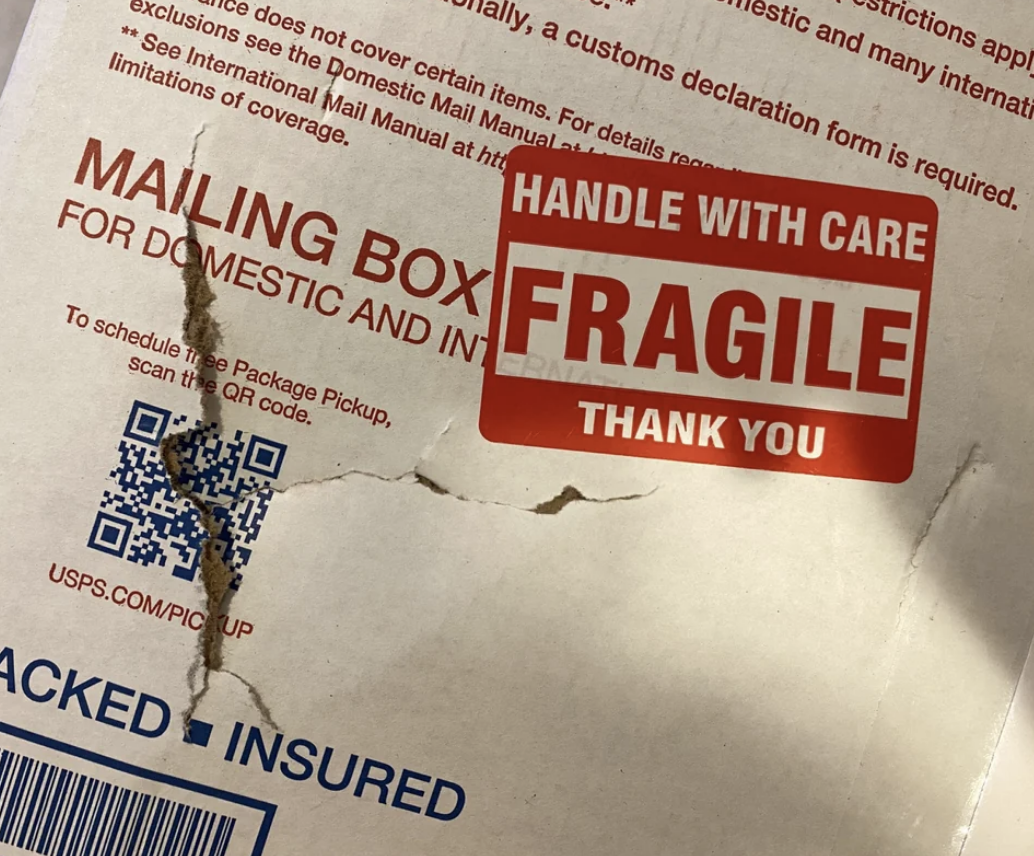 Ruined package with Fragile sign on it