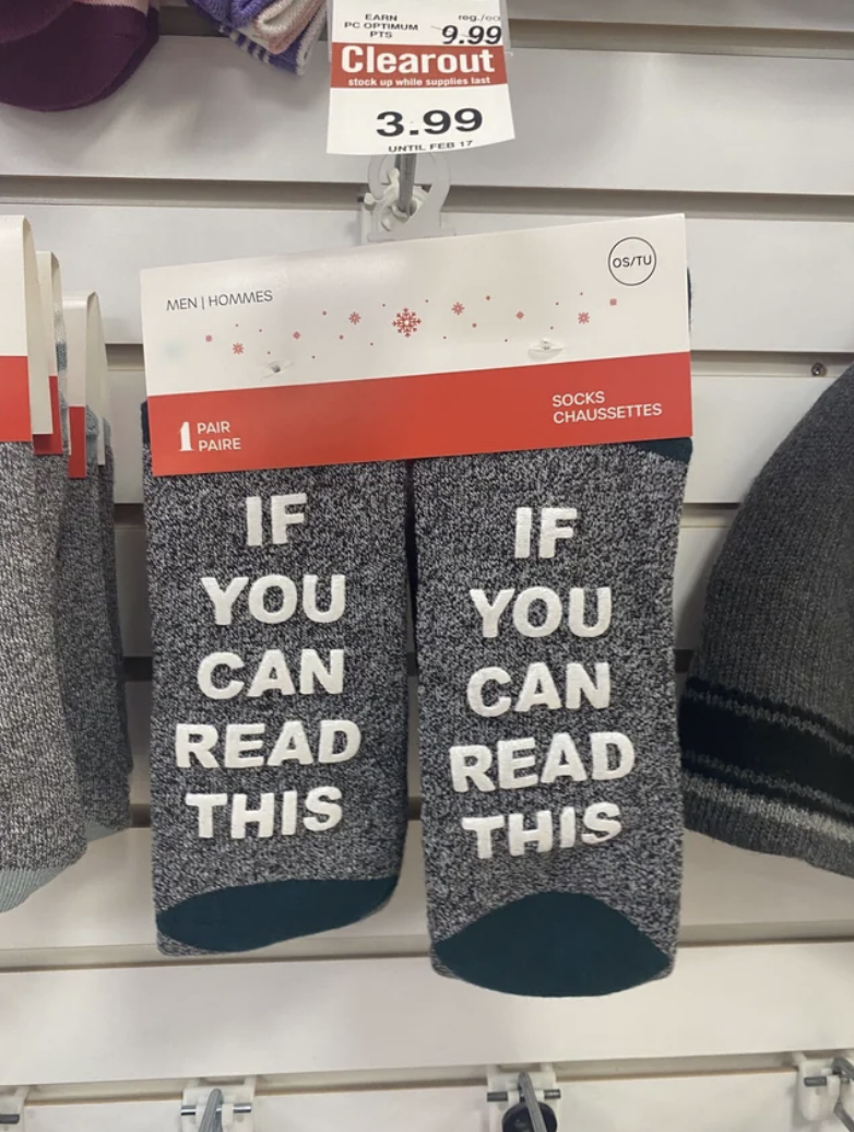 Two pairs of socks that read: &quot;If you can read this&quot;