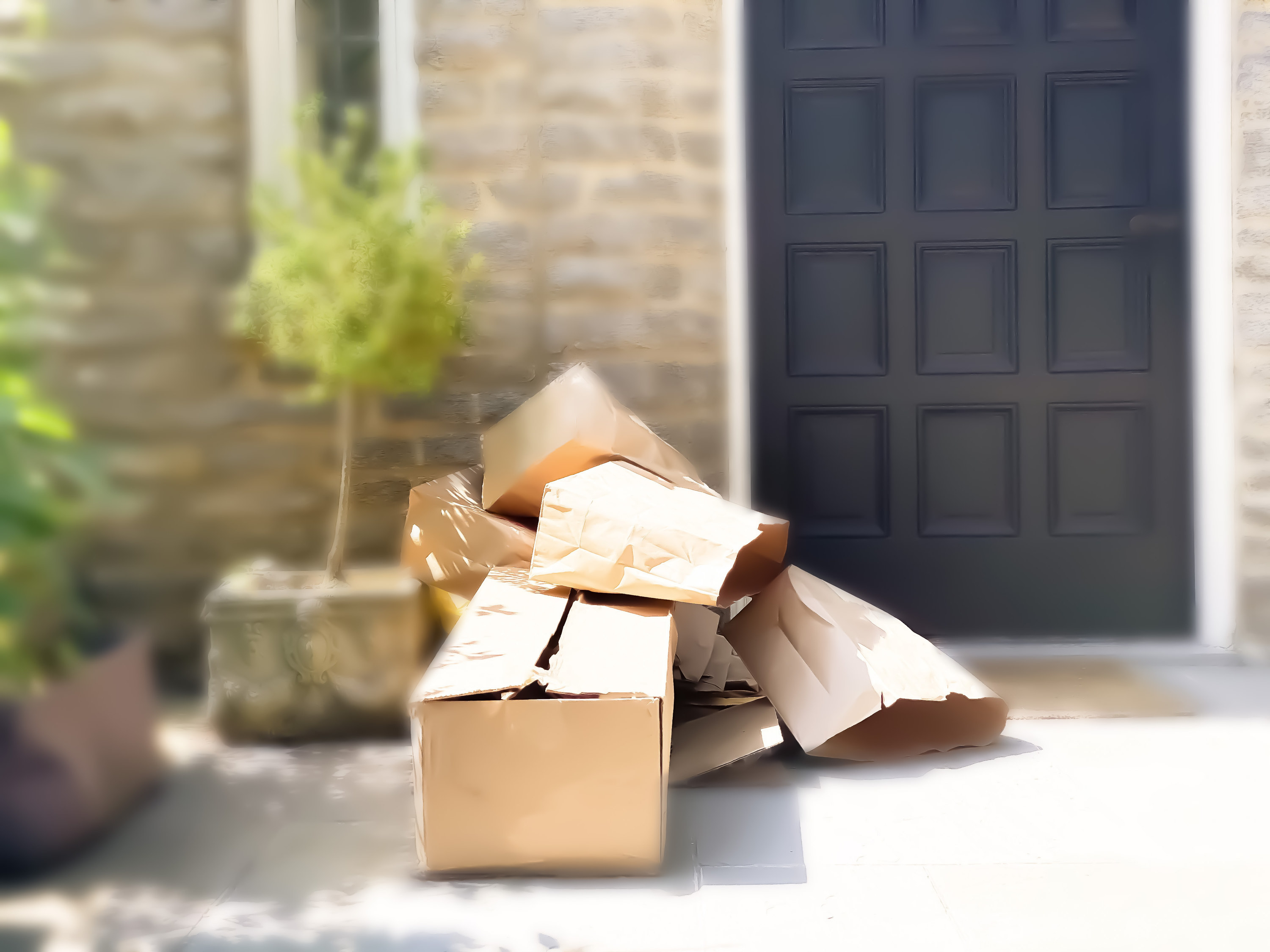 Pile of shipping boxes on a front doorstep