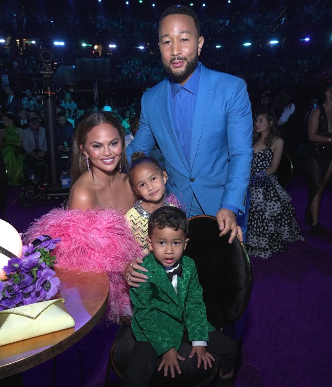 Chrissy and John taking a photo with Luna and Miles