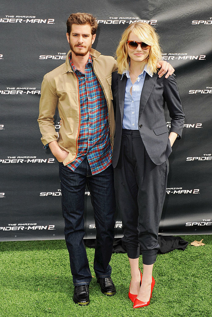 Andrew and Emma standing on grass with their arms around each other