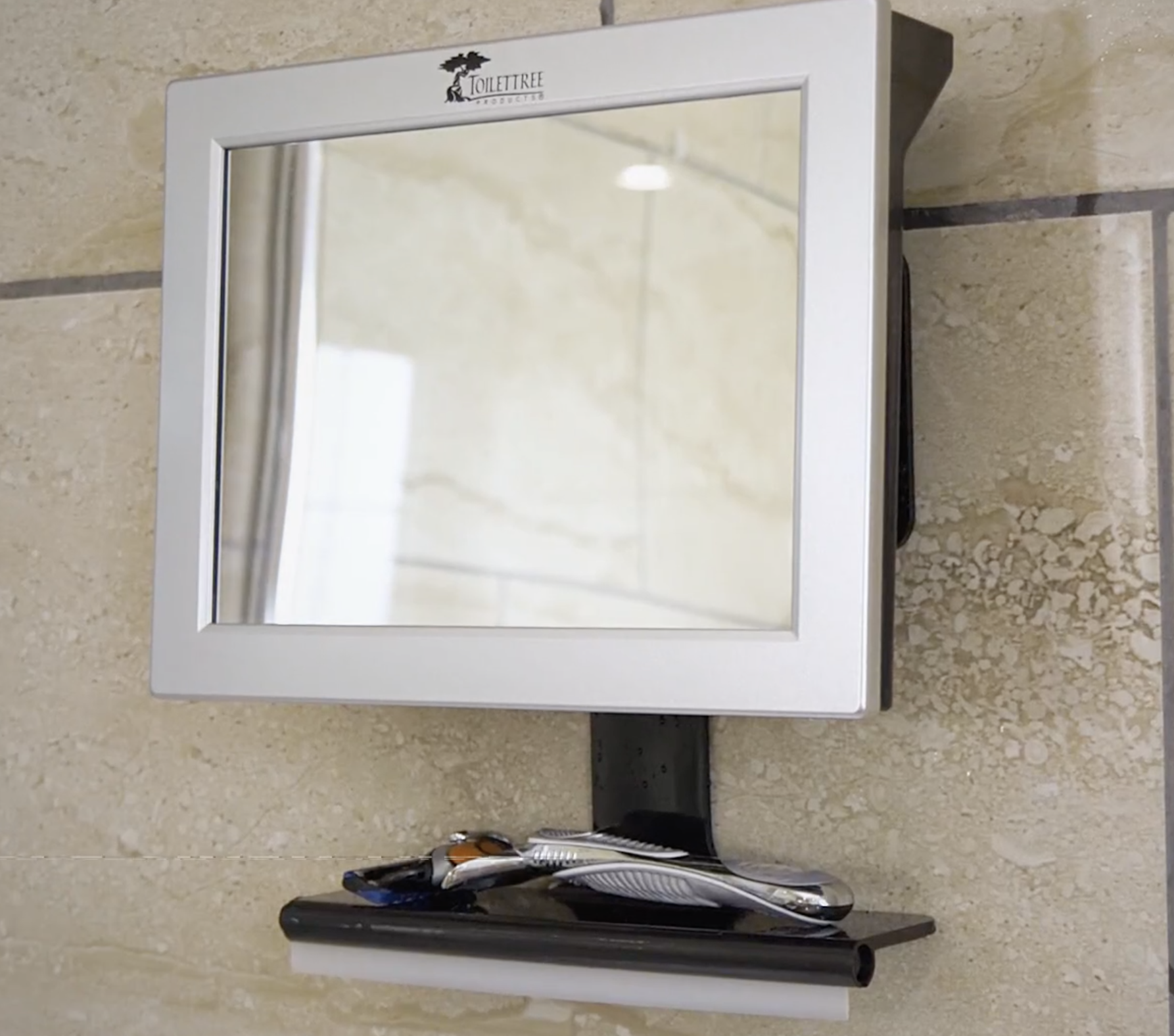 the mirror attached to a shower wall