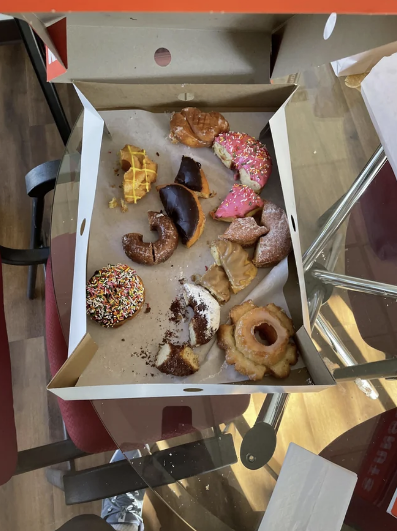 Half-eaten donuts in a box