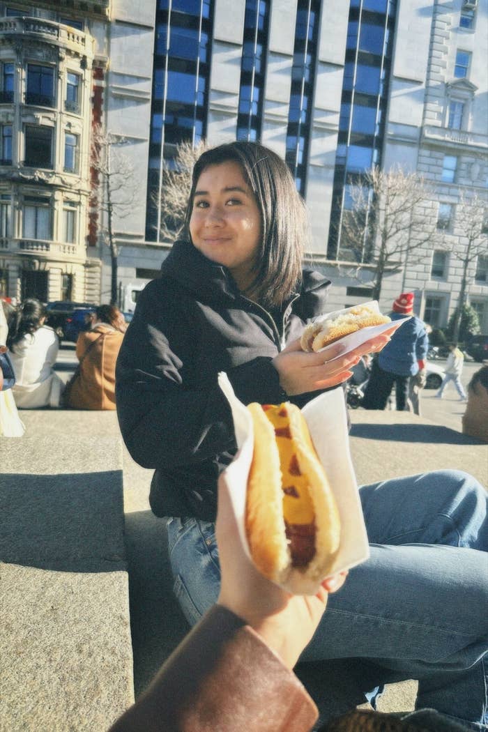 Woman eating a hot dog