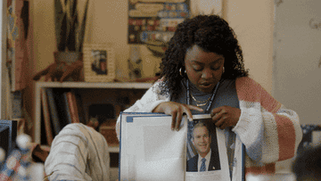 woman flipping through book showing President Obama