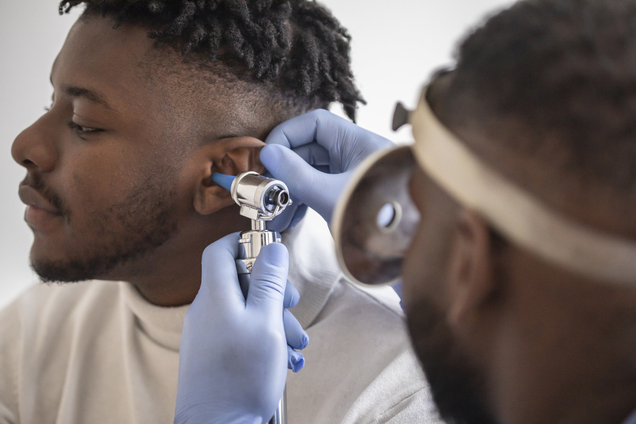 Doctor checking patient&#x27;s ear