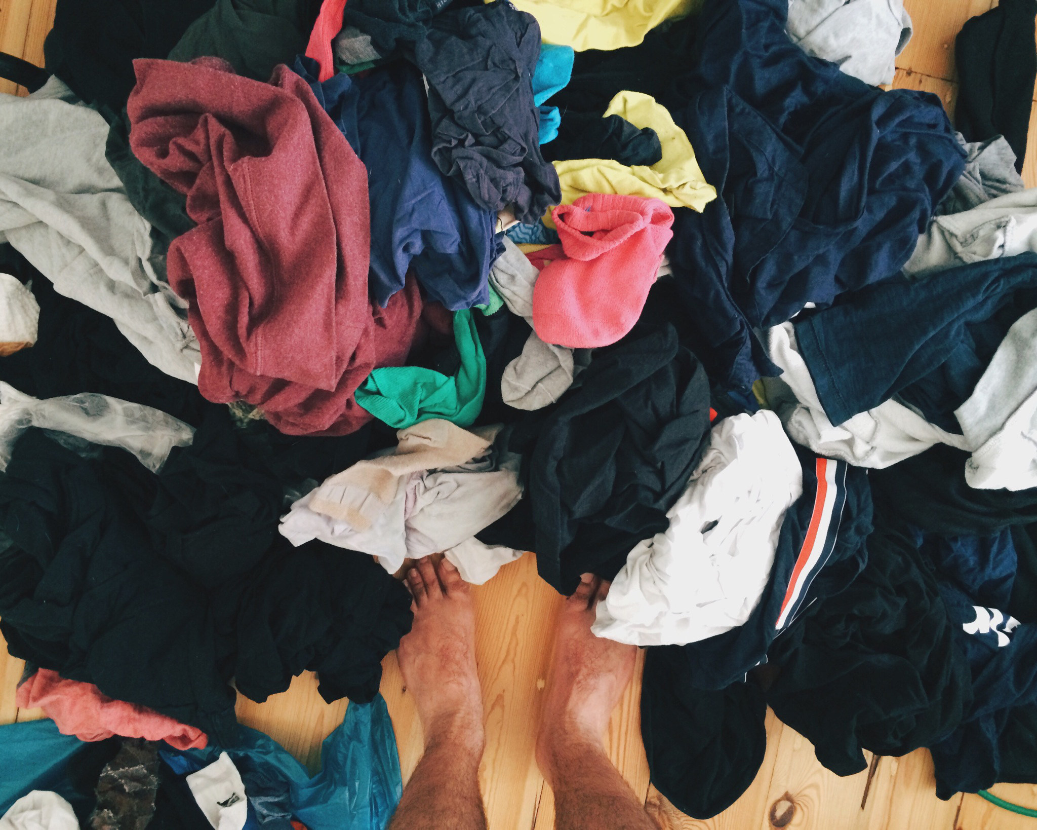 Standing above a messy pile of laundry