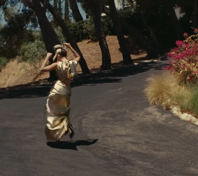 Miley Cyrus dancing up a driveway in "Flowers"